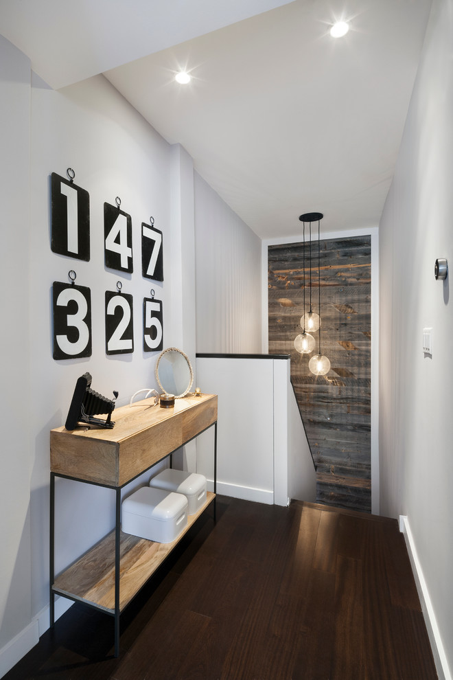 Inspiration for a mid-sized contemporary dark wood floor and brown floor hallway remodel in New York with white walls