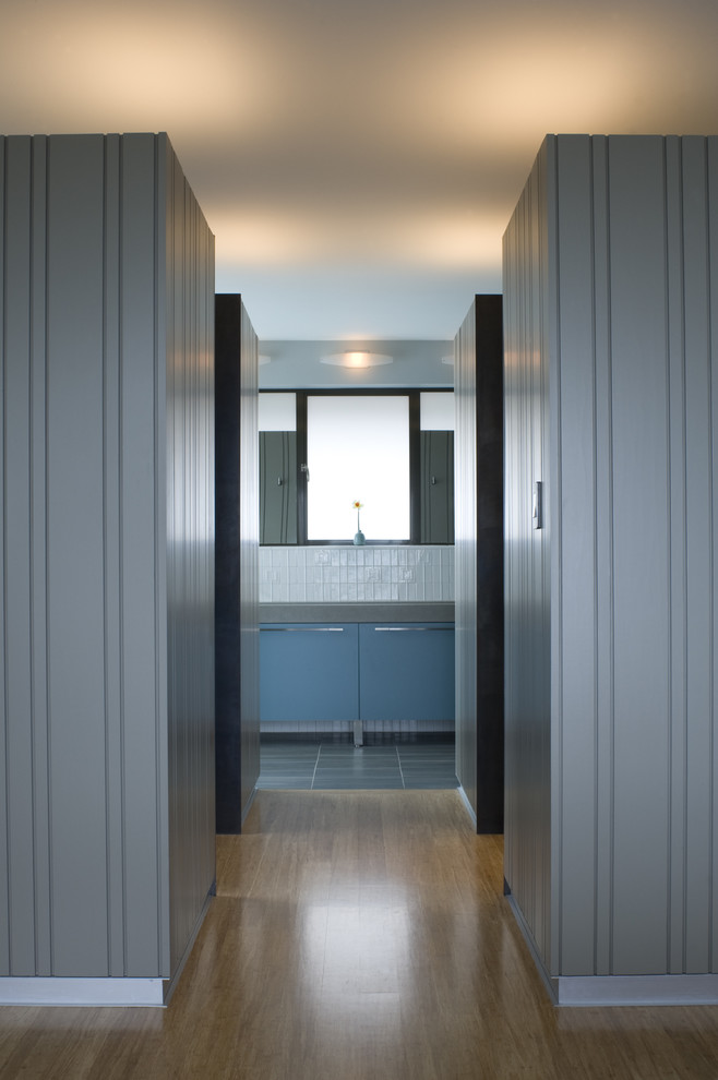 Hallway - contemporary medium tone wood floor hallway idea in San Francisco with gray walls