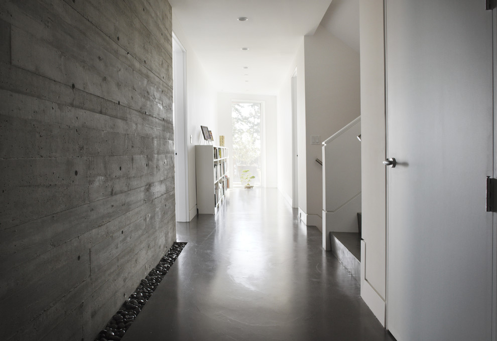 Example of a minimalist concrete floor and gray floor hallway design in Vancouver