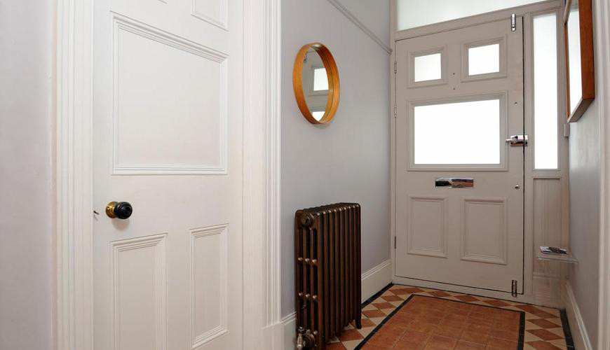 На фото: большой коридор в стиле фьюжн с серыми стенами, полом из керамической плитки и разноцветным полом с