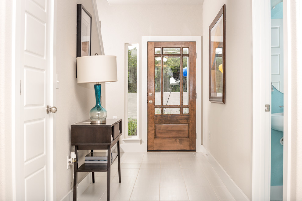 Example of a mid-sized trendy porcelain tile hallway design in Austin with beige walls
