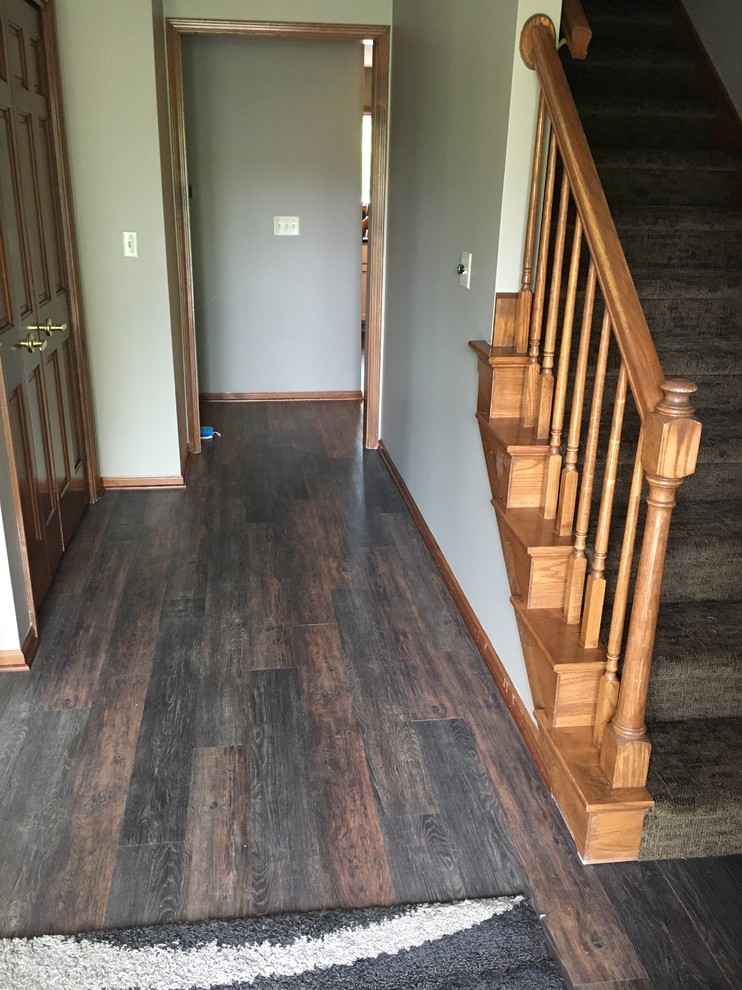 Example of a mid-sized trendy dark wood floor and brown floor hallway design in Other with gray walls