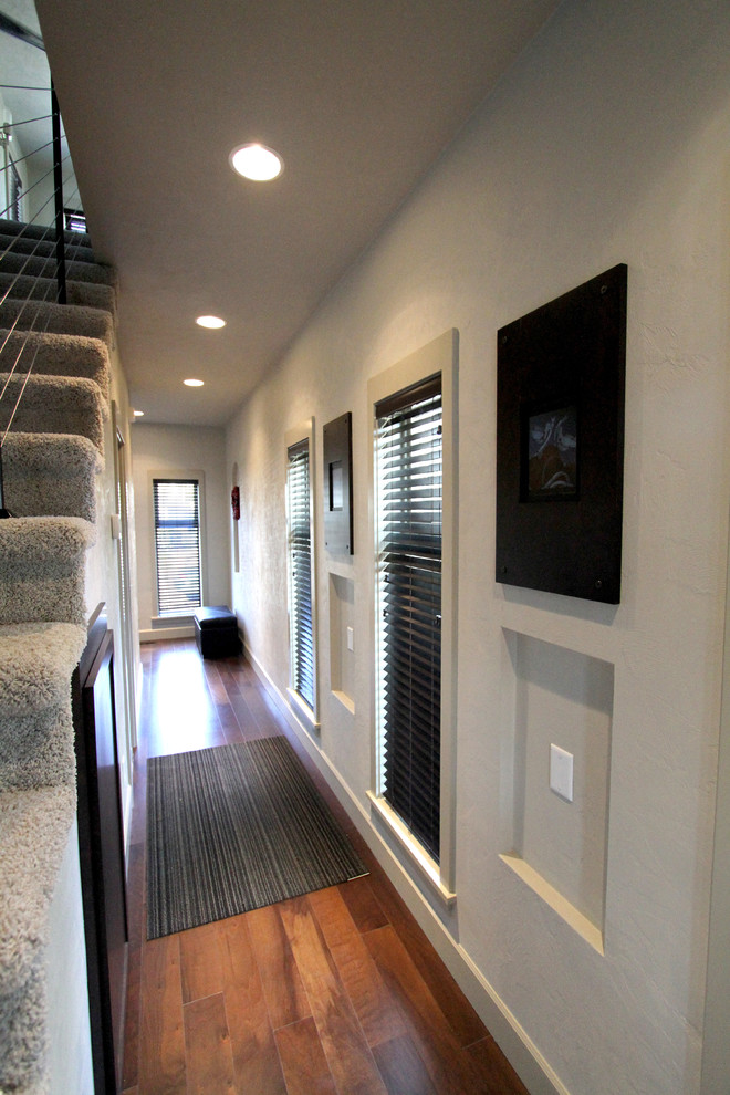 Inspiration for a mid-sized modern medium tone wood floor hallway remodel in Portland with gray walls