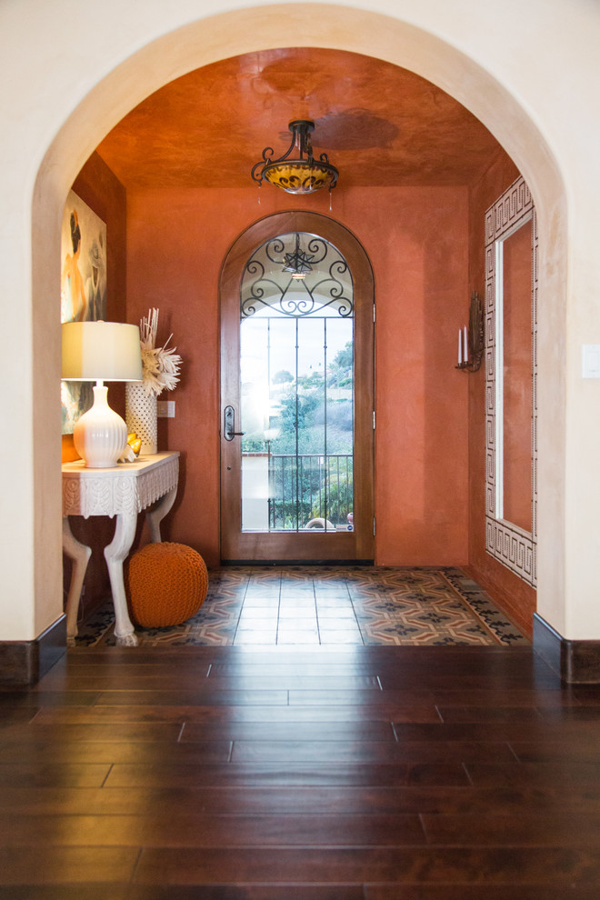 Mid-sized tuscan porcelain tile hallway photo in Other with orange walls