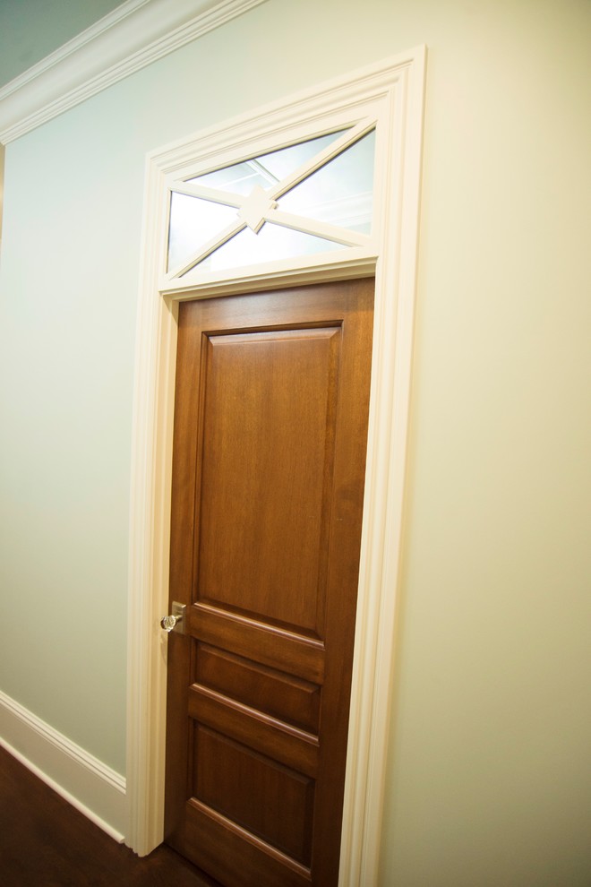 Example of a mid-sized cottage medium tone wood floor hallway design in Other with blue walls