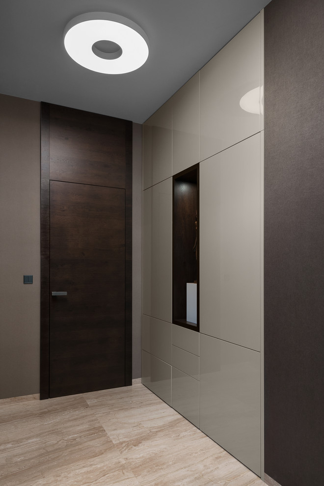 Cette image montre un grand couloir minimaliste avec un mur marron et un sol en marbre.