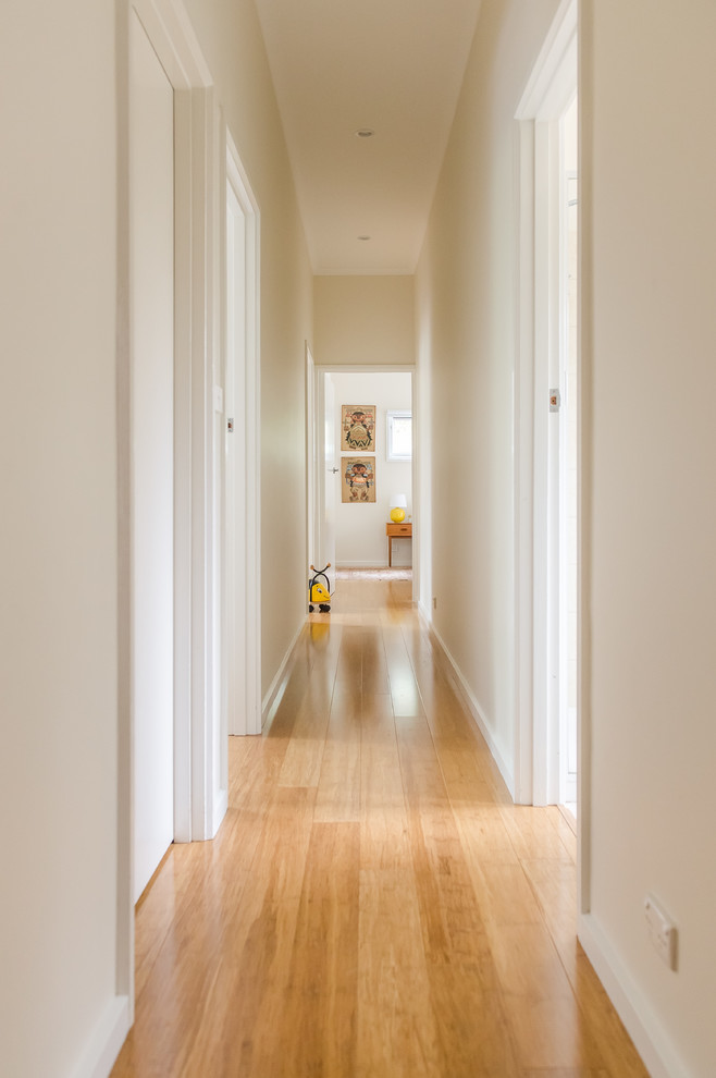 Стильный дизайн: коридор среднего размера в скандинавском стиле с бежевыми стенами и полом из бамбука - последний тренд