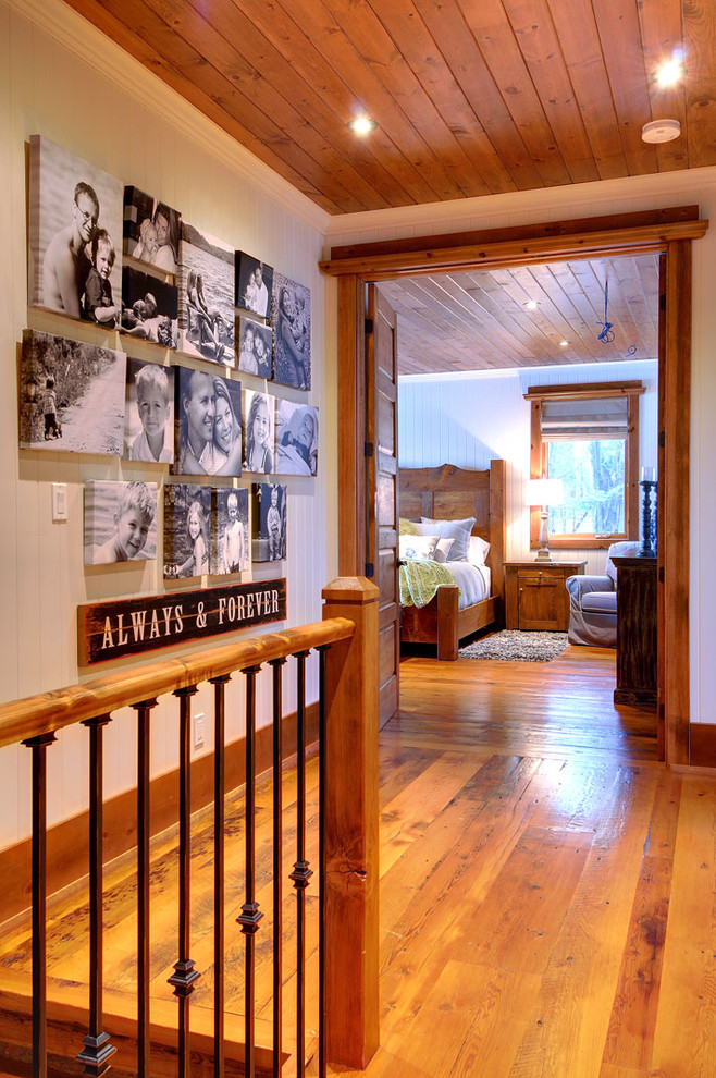 Inspiration for a rustic medium tone wood floor hallway remodel in Toronto with white walls