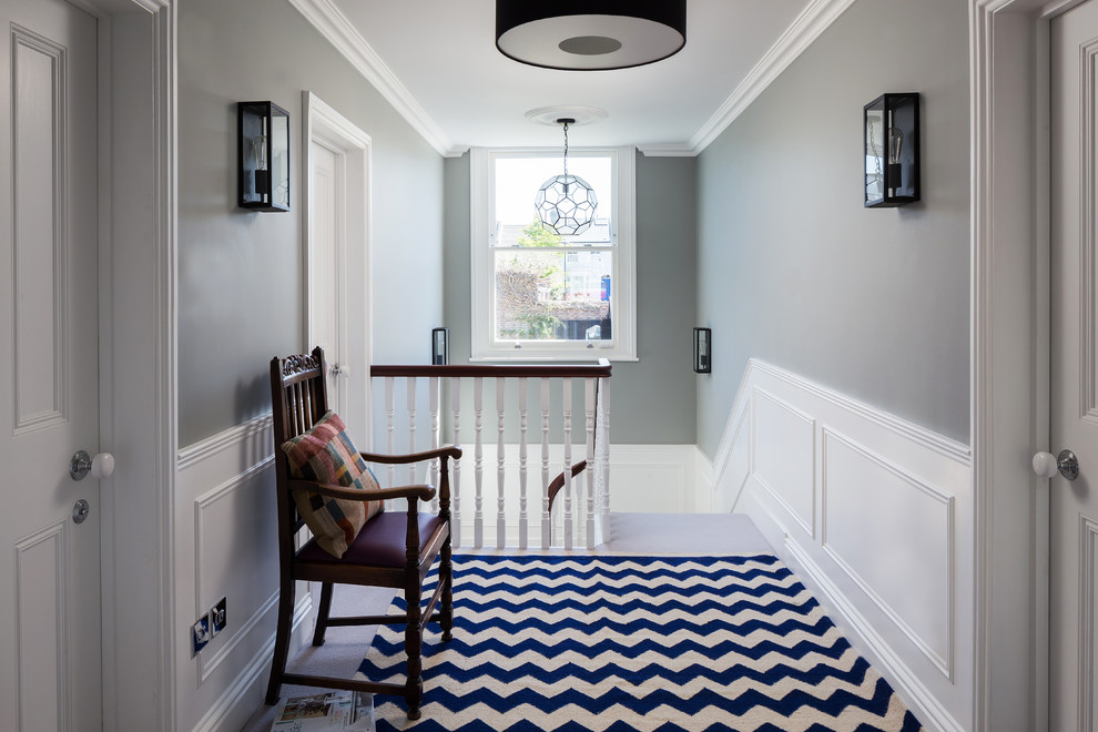 Hallway - traditional carpeted hallway idea in London with gray walls
