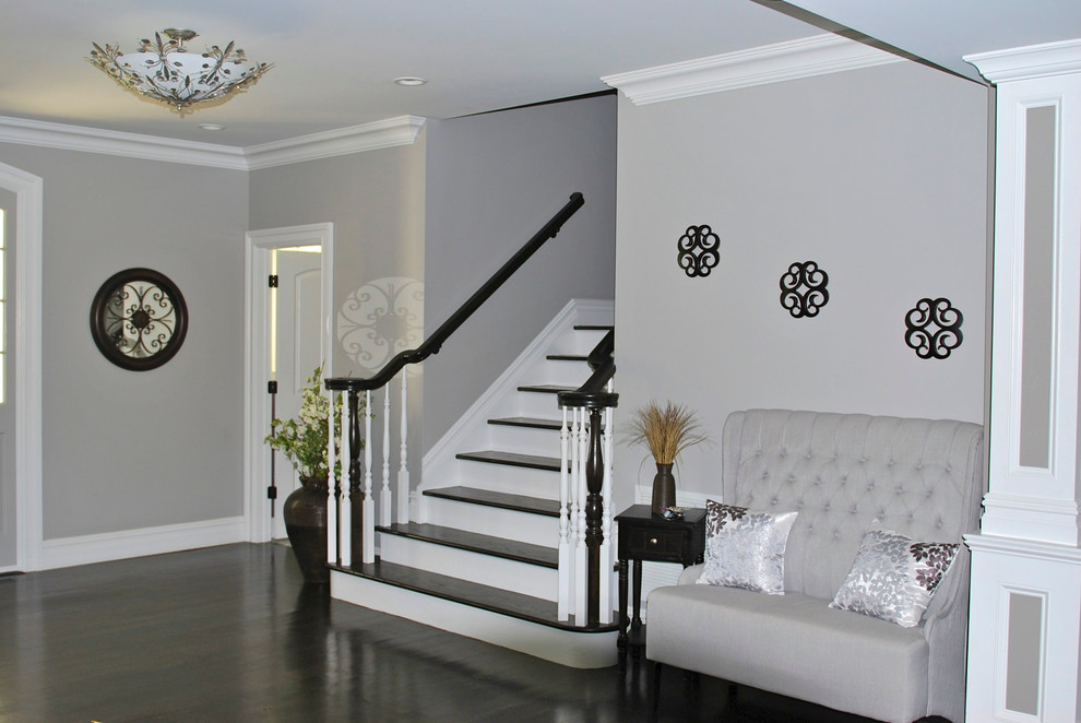 Example of a large cottage dark wood floor hallway design in New York with gray walls