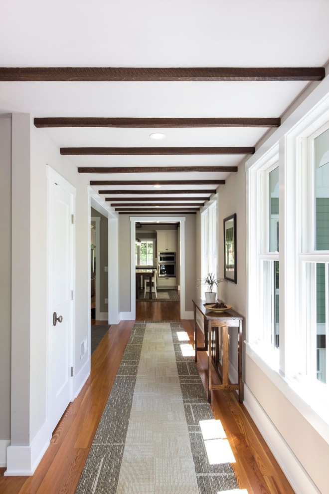 Example of a mid-sized classic medium tone wood floor and brown floor hallway design in DC Metro with gray walls