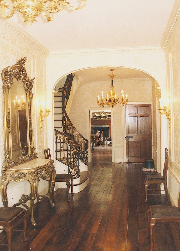 Example of a mid-sized country medium tone wood floor hallway design in New York with multicolored walls