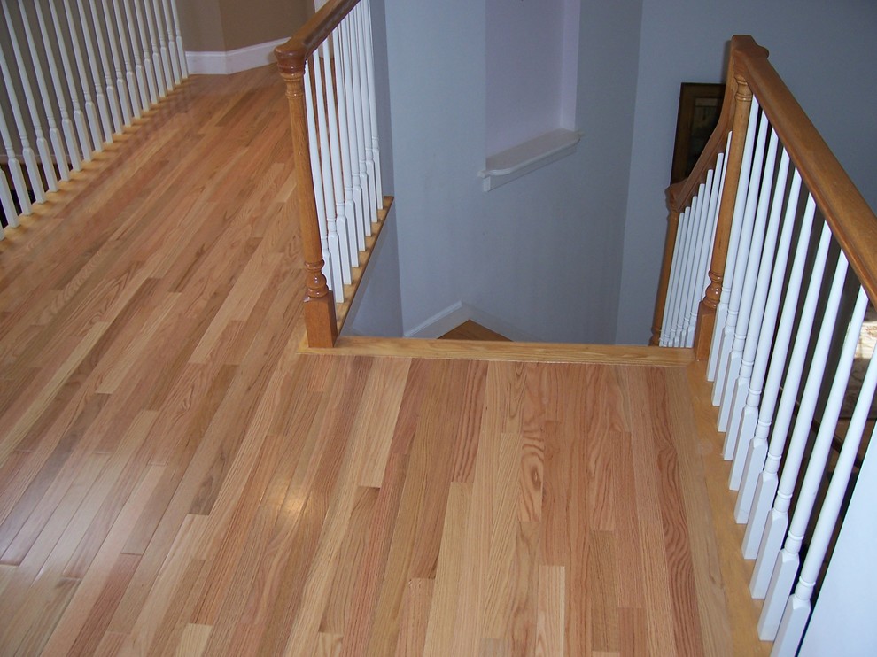 Inspiration for a small timeless light wood floor and beige floor hallway remodel in Boston with brown walls