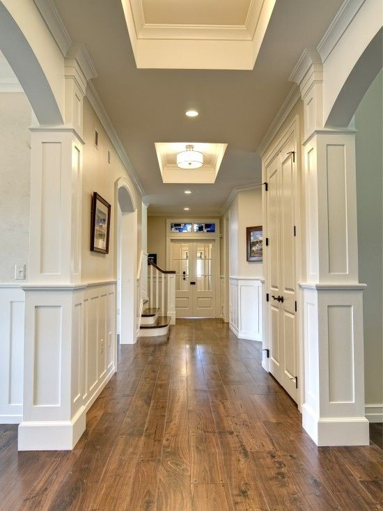 Mid-sized transitional medium tone wood floor and brown floor hallway photo in Phoenix with white walls