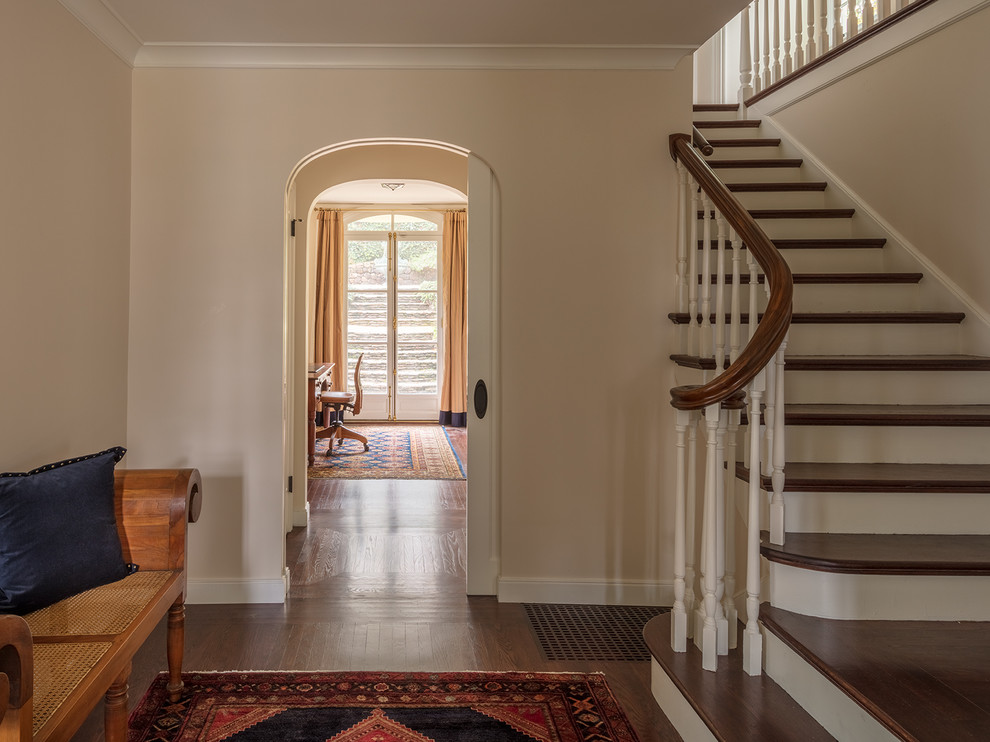 Example of a mid-sized transitional dark wood floor and brown floor hallway design in San Francisco with beige walls