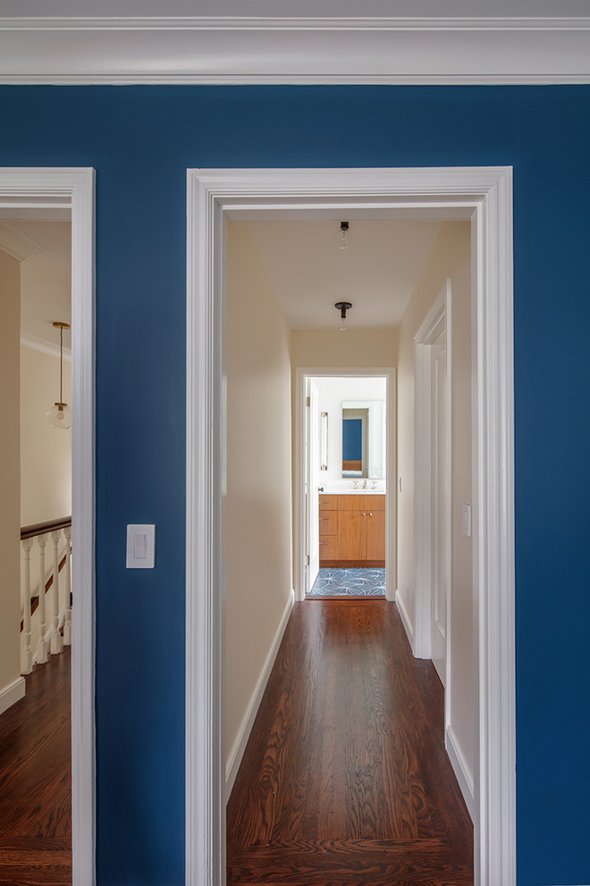 Idée de décoration pour un petit couloir tradition avec un mur bleu, parquet foncé et un sol marron.