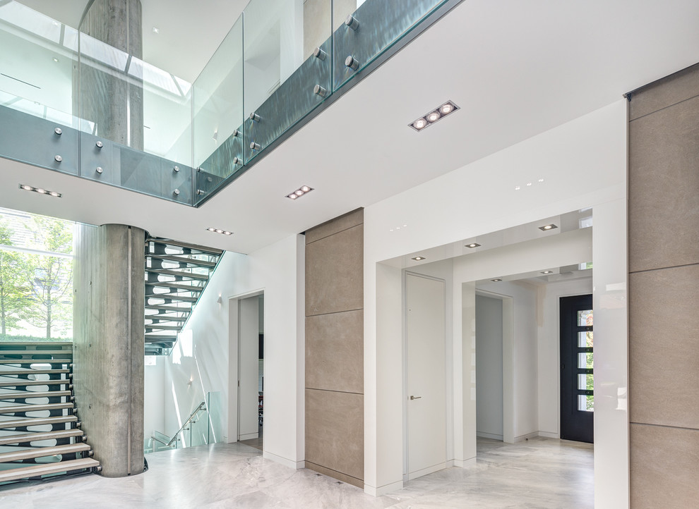 Example of a large transitional marble floor hallway design in Toronto with white walls