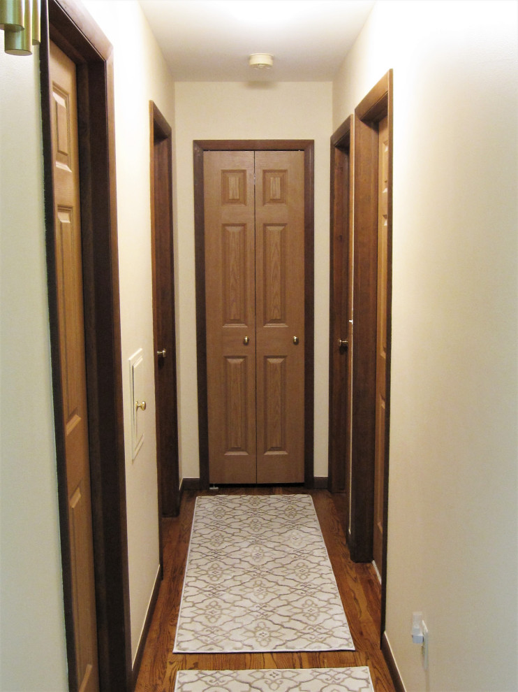 Klassischer Flur mit beiger Wandfarbe, dunklem Holzboden und braunem Boden in Detroit