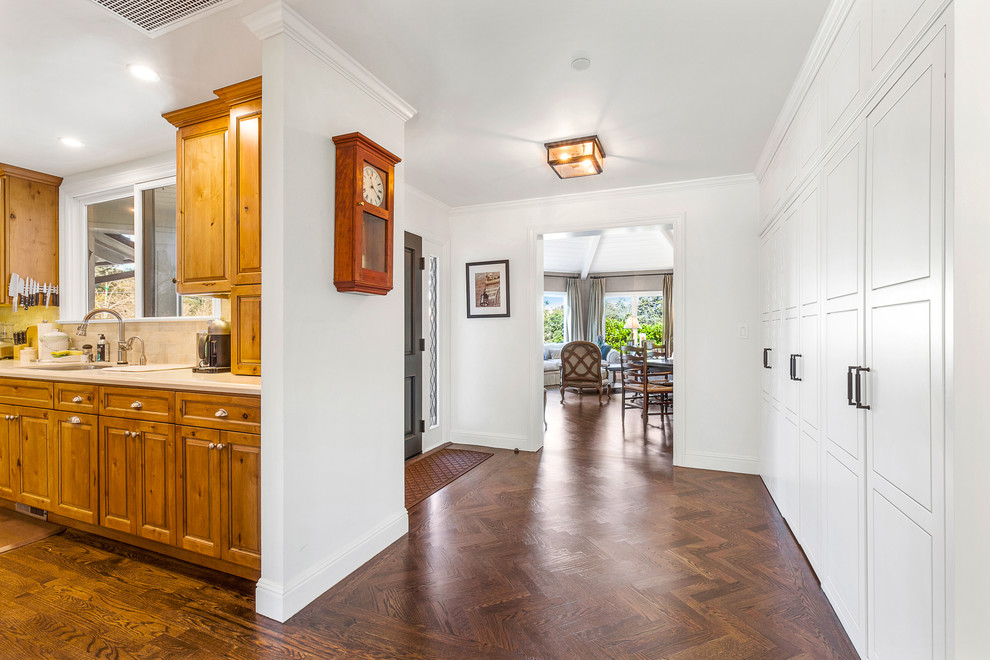 Mid-sized arts and crafts medium tone wood floor hallway photo in San Francisco with white walls