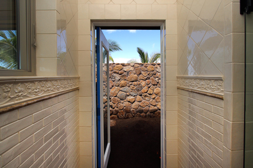 Example of a small island style hallway design in Hawaii with beige walls