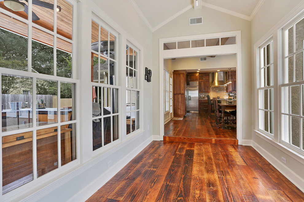 Inspiration for a craftsman medium tone wood floor hallway remodel in New Orleans with green walls