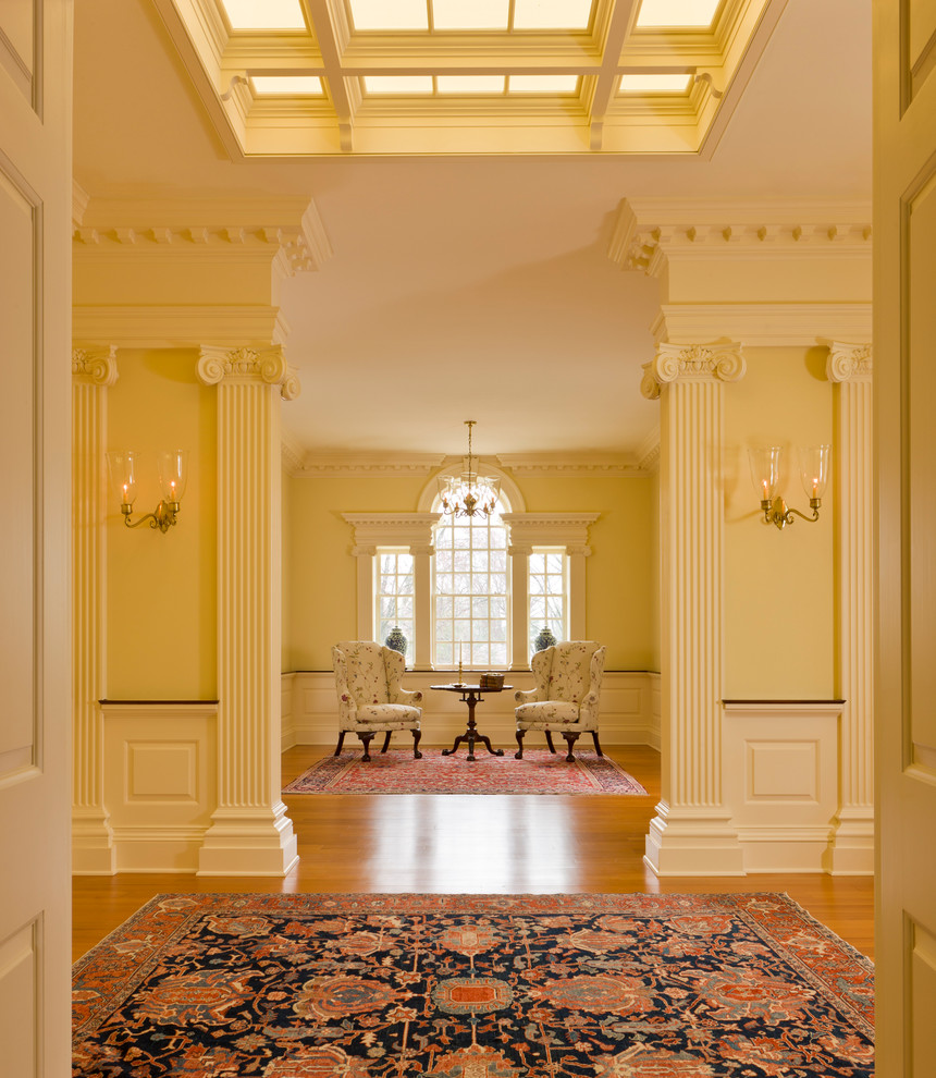 Inspiration for a timeless medium tone wood floor hallway remodel in DC Metro with yellow walls