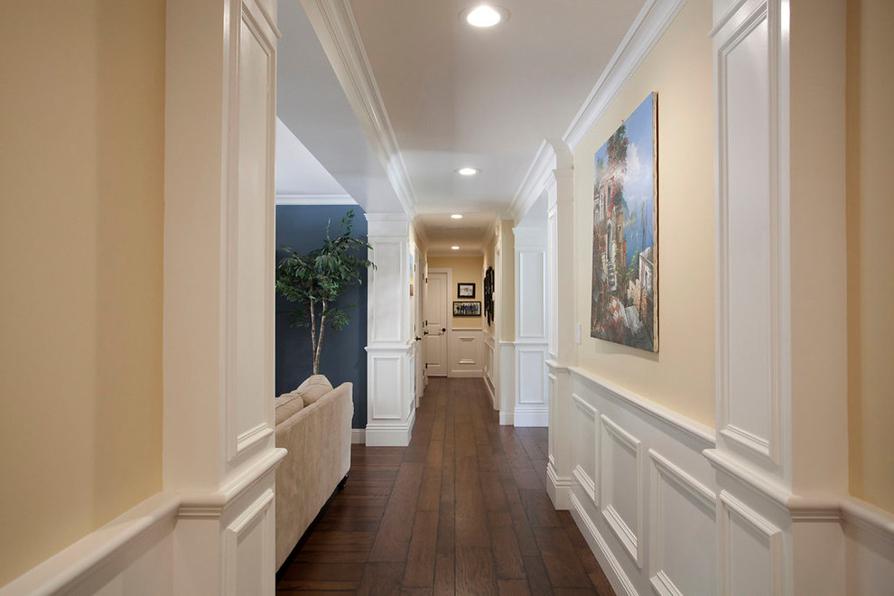 Example of a large classic dark wood floor and brown floor hallway design in San Francisco with beige walls