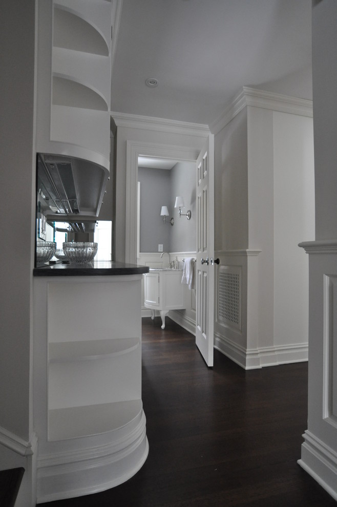 Inspiration for a mid-sized timeless dark wood floor and brown floor hallway remodel in New York with gray walls