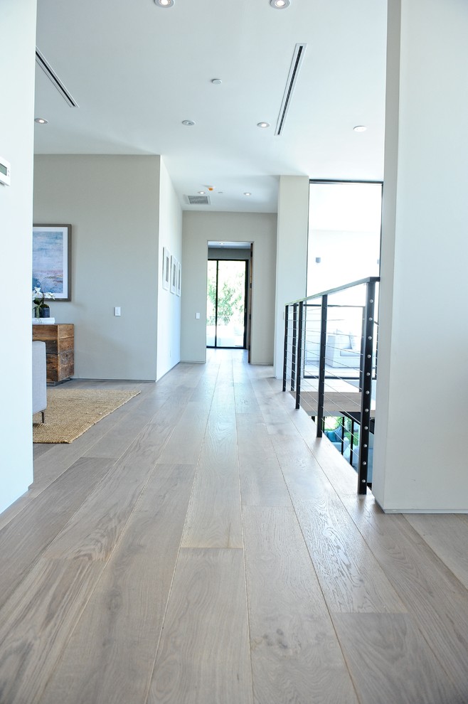 Example of a trendy medium tone wood floor hallway design in Los Angeles