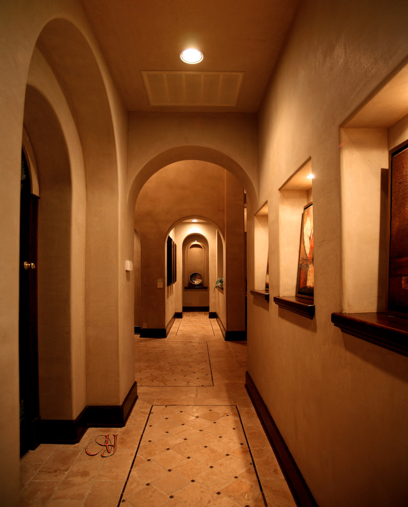 Inspiration for a mid-sized mediterranean hallway remodel in Austin with beige walls