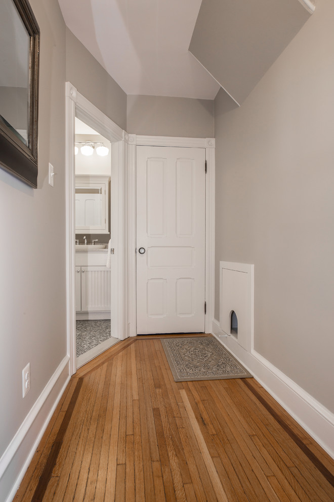 Hallway - mid-sized traditional medium tone wood floor and brown floor hallway idea in Philadelphia with gray walls
