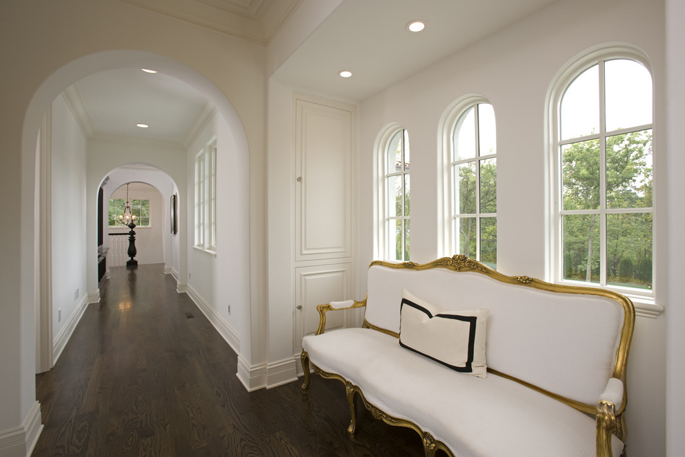 Example of a tuscan dark wood floor hallway design in Minneapolis with white walls
