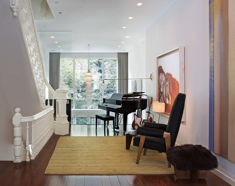 Photo of a classic living room in New York with white walls and dark hardwood flooring.