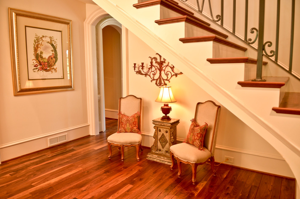 Example of a mid-sized classic medium tone wood floor hallway design in Atlanta with white walls