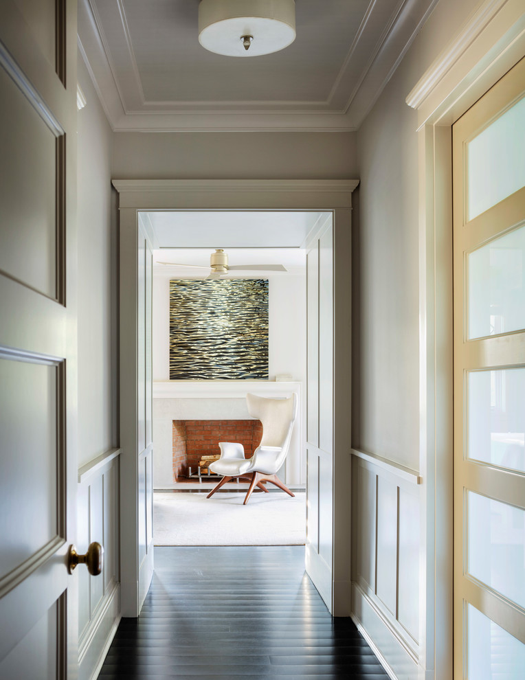 Transitional dark wood floor hallway photo in New York with multicolored walls