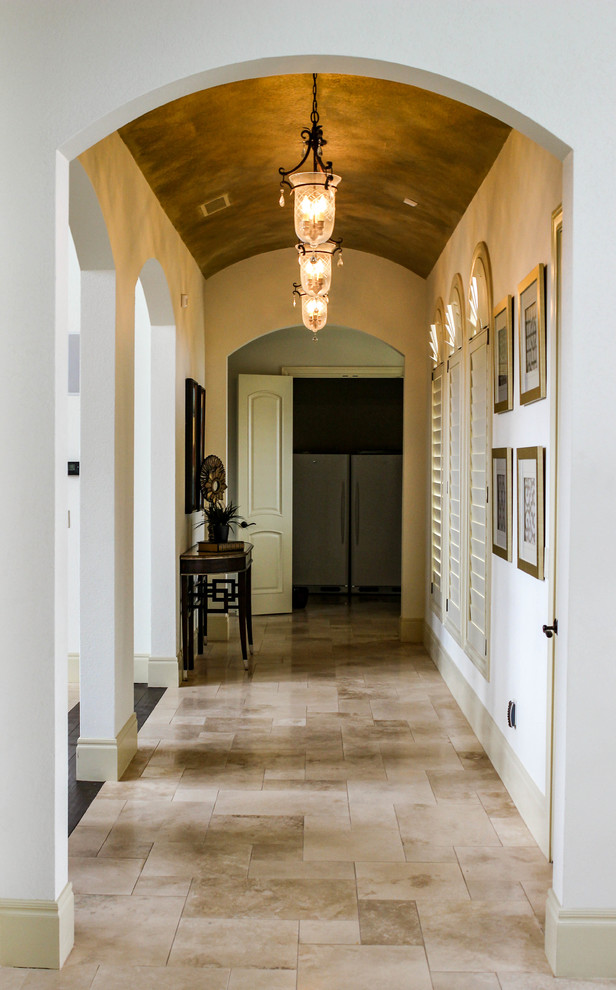 Hallway - traditional porcelain tile hallway idea in Austin with white walls