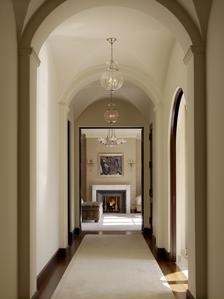 Hallway - mediterranean medium tone wood floor hallway idea in San Francisco with beige walls