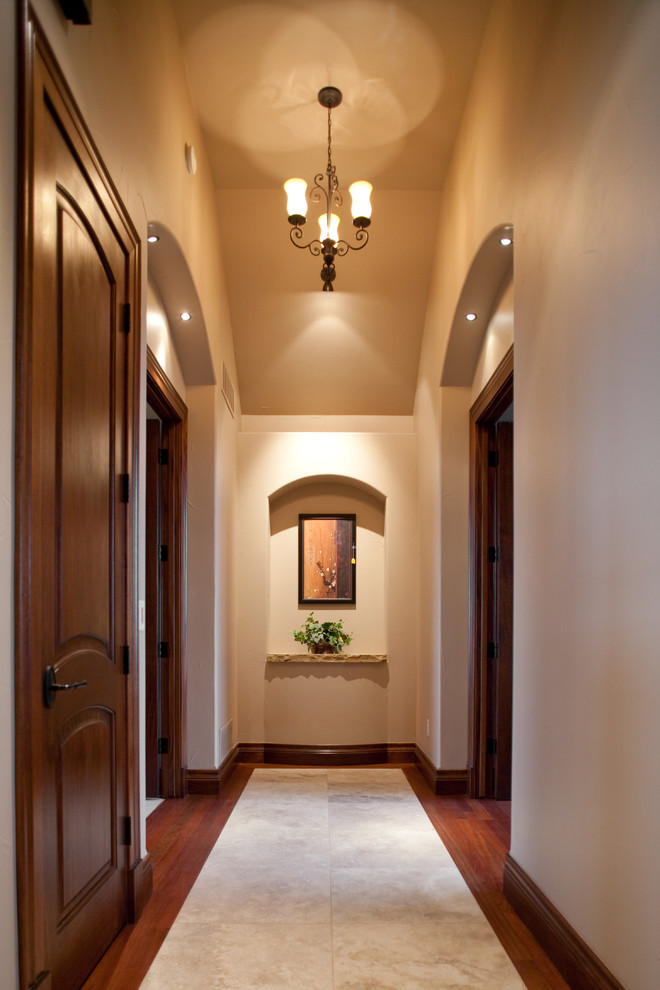 Idée de décoration pour un couloir design avec un mur beige, un sol en bois brun et un sol multicolore.