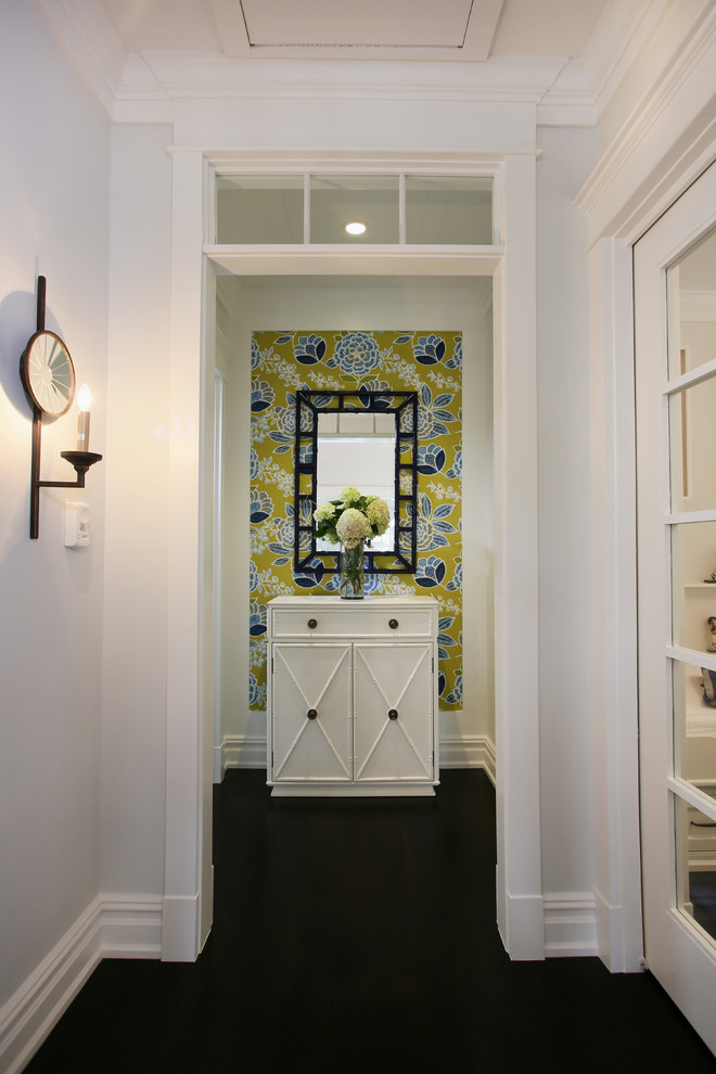 Example of a small beach style dark wood floor hallway design in Philadelphia with white walls