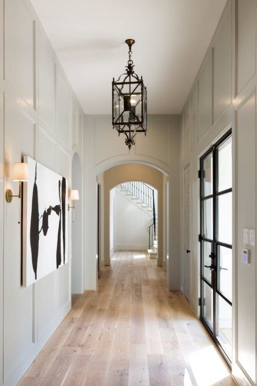 Hallway - contemporary light wood floor hallway idea in Houston