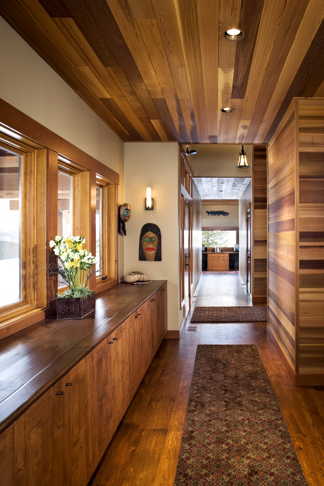 Inspiration for a mid-sized contemporary medium tone wood floor and brown floor hallway remodel in Boise with beige walls