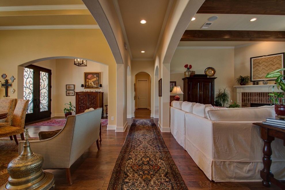 Example of a classic dark wood floor and brown floor hallway design in Austin with white walls