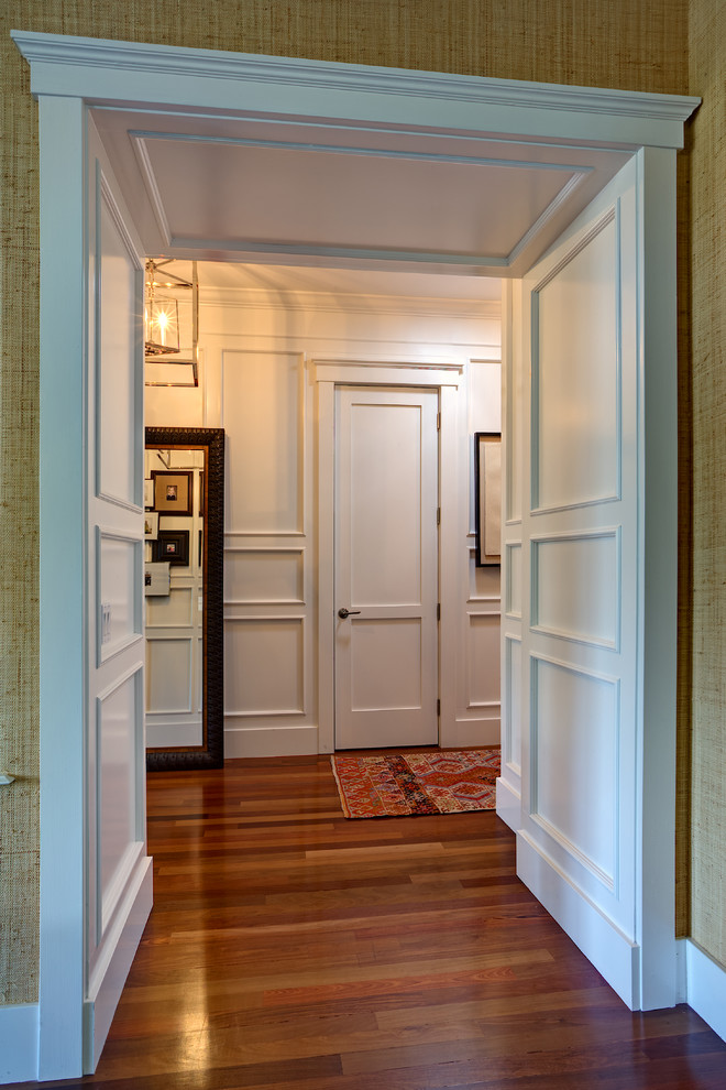 Réalisation d'un couloir tradition de taille moyenne avec un mur beige et un sol en bois brun.