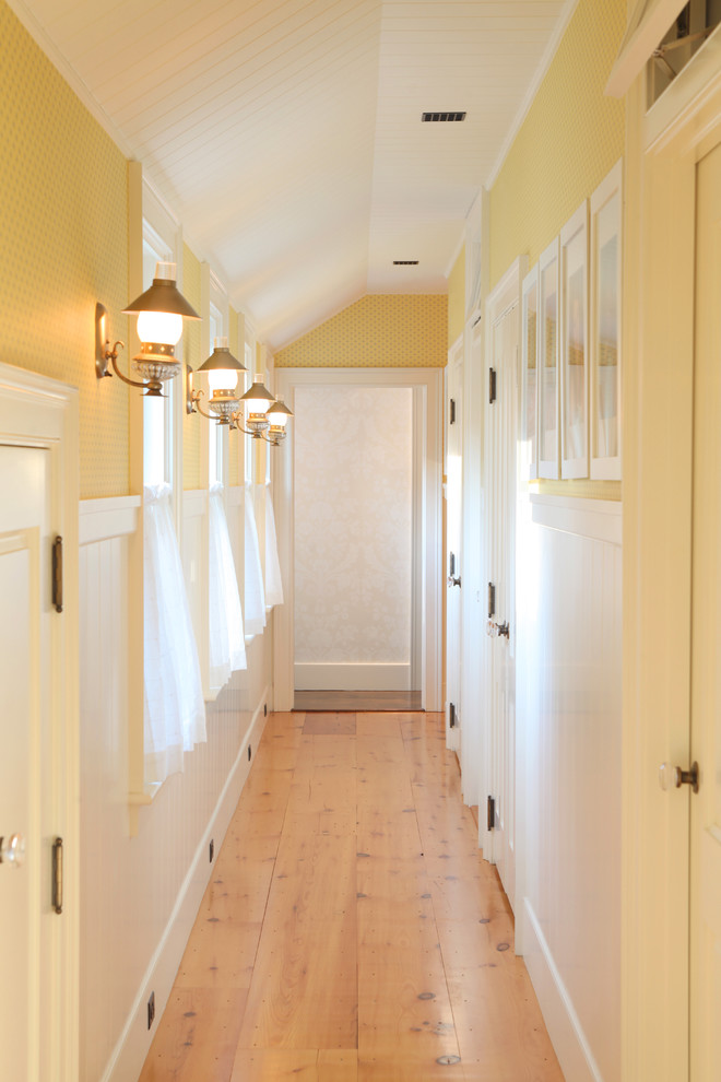 Mid-sized elegant light wood floor and beige floor hallway photo in Boston with yellow walls