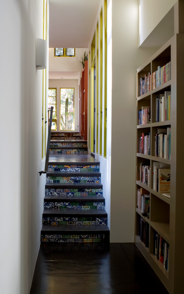 Example of a mid-sized trendy brown floor hallway design with white walls
