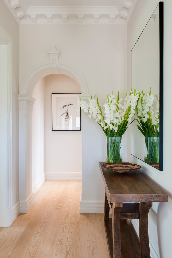 Hallway - contemporary light wood floor hallway idea in Sydney with beige walls