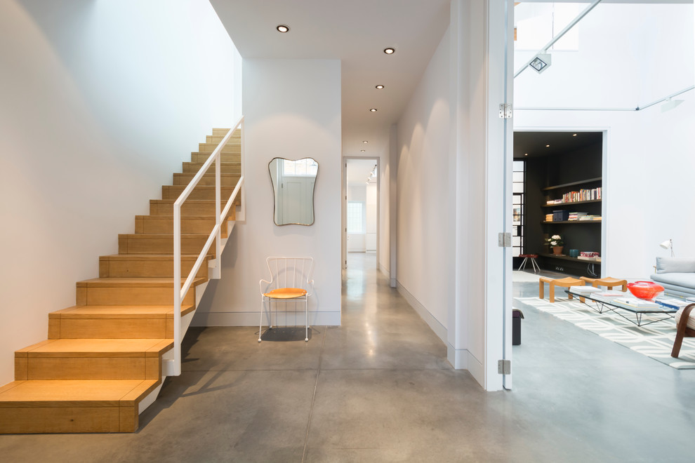 Источник вдохновения для домашнего уюта: огромный коридор в стиле лофт с белыми стенами и бетонным полом