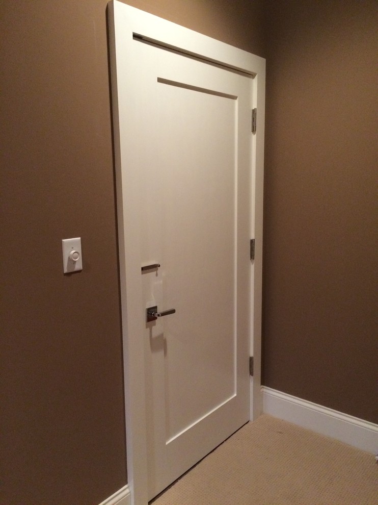 Example of a mid-sized classic carpeted and beige floor hallway design in Indianapolis with brown walls