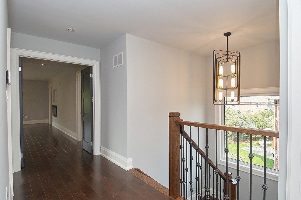 Inspiration for a mid-sized contemporary medium tone wood floor and brown floor hallway remodel in Toronto with beige walls