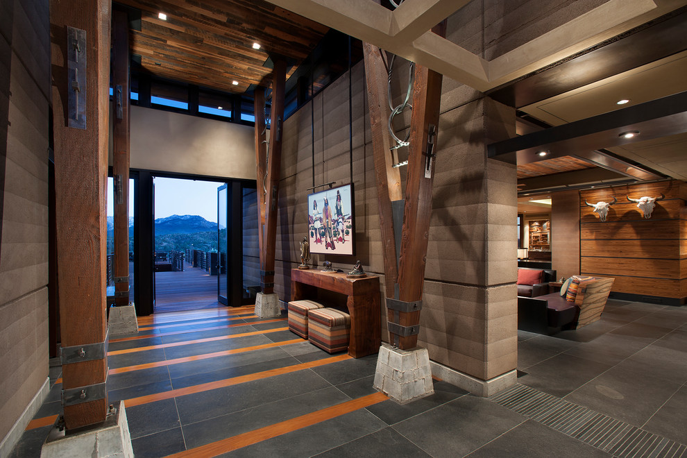 Inspiration for a large southwestern slate floor and gray floor hallway remodel in Phoenix with brown walls